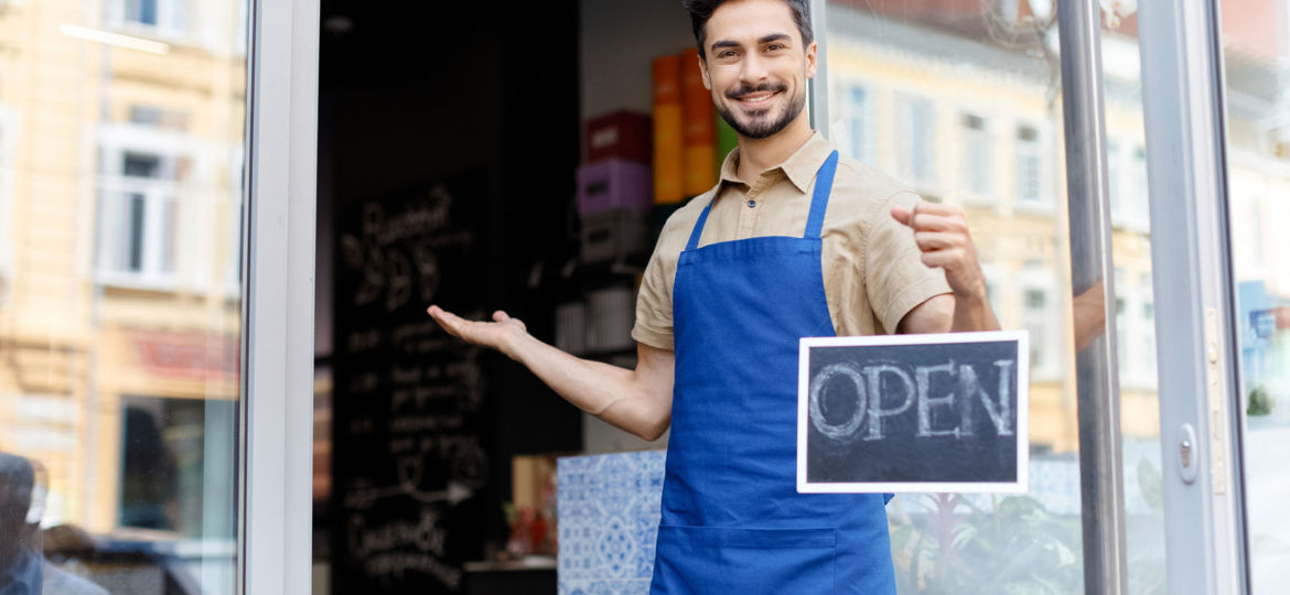 Bakery Worker holding Open Sign